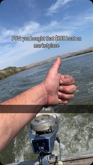 Thumbs up over open Delta water behind a small vintage outboard at speed.